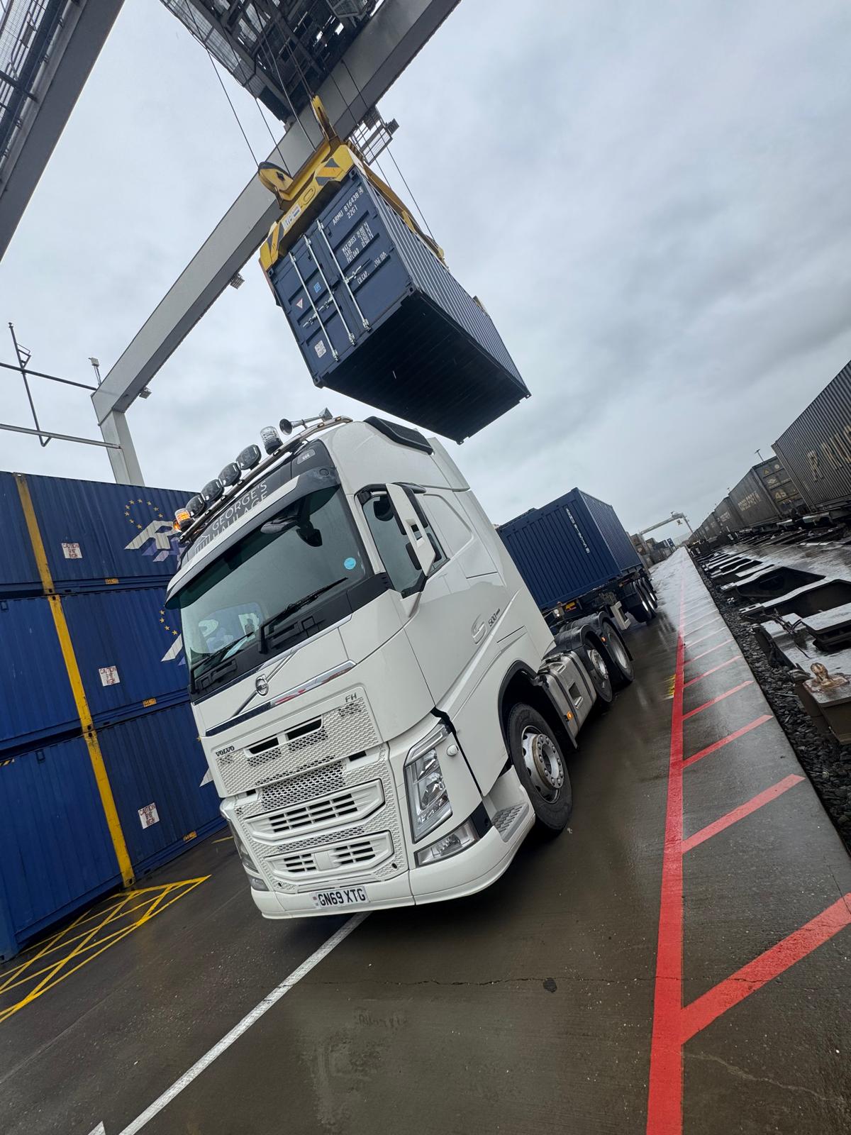 Container being craned onto a George's Haulage truck at the rail terminal