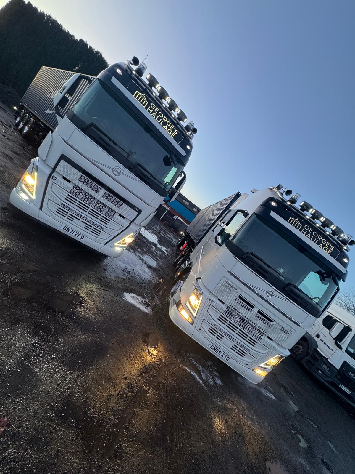 Two George's Haulage Volvos at dusk