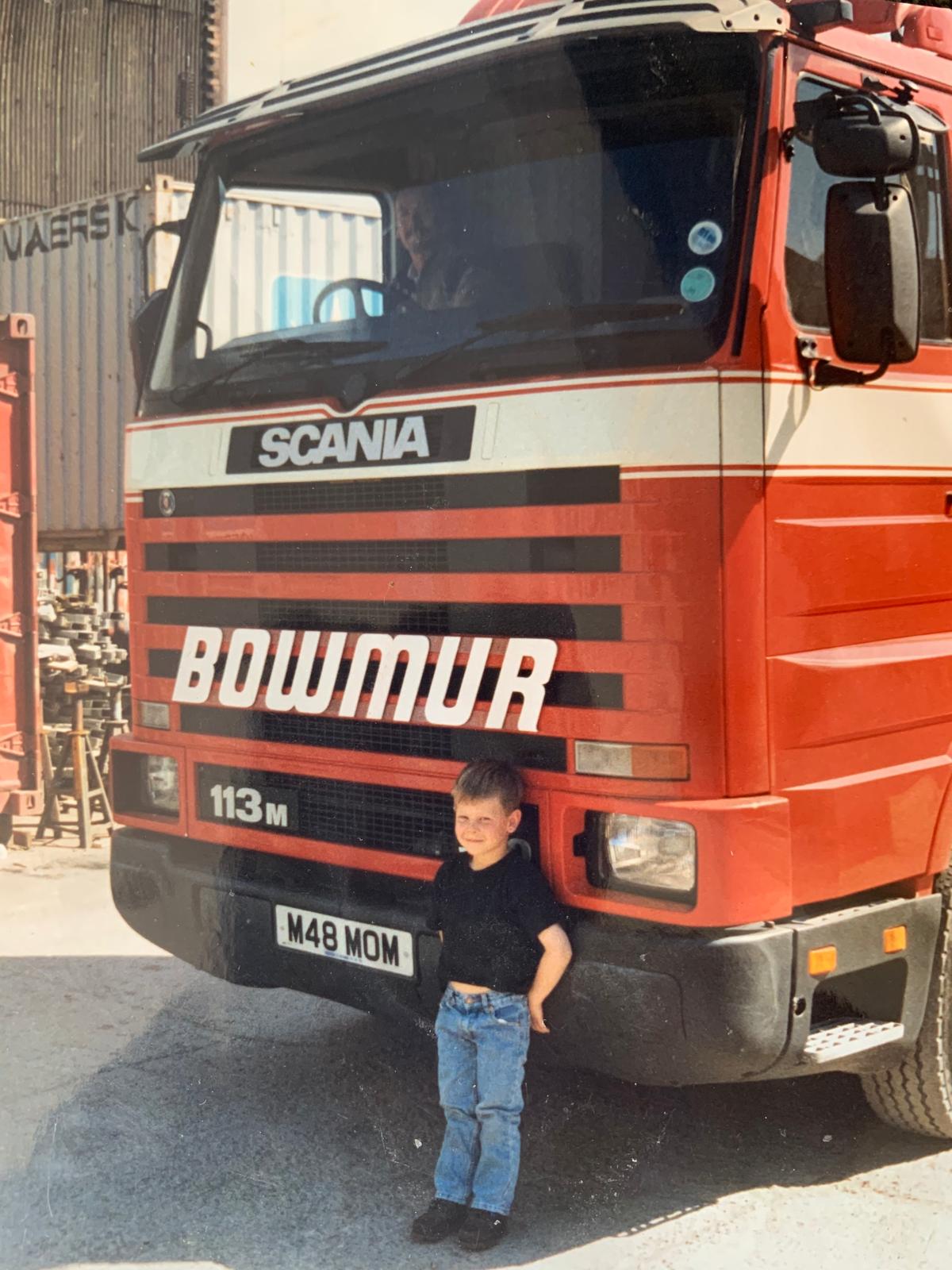 Young George in front of a Bowmur Scania truck